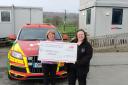 Val Jones presenting the Cheque to a representative from Wales Air Ambulance