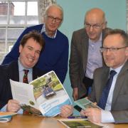 Montgomeryshire’s MP Craig Williams and Assembly Member Russell George discuss the 10-year Montgomery Canal restoration plan with Montgomery Waterway Restoration Trust chair Michael Limbrey (standing left) and Montgomery Canal Partnership chair