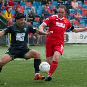 Adrian Cieslewicz of TNS and Newtown's Craig Williams in action. Picture by H18-PDW Photography.