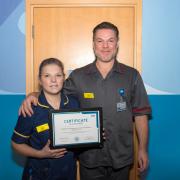 Lillie Birch, Professional Development Nurse for International Recruitment, and Paul Kavanagh-Fields, Chief Nurse and Patient Safety Officer, with the NHS Pastoral Care Quality Award certificate.