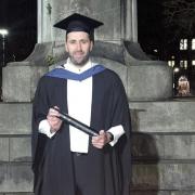 Ryan Astles celebrates his degree.
