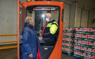 The Prince of Wales (right) is shown a forklift truck by Iceland Executive Chairman, Sir Malcolm Walker, during a visit to the headquarters of Iceland Foods Ltd, Flintshire, to celebrate the company's 50th anniversary and learn about their