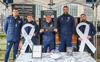 The New Saints FC players at the White Ribbon Day market stall.