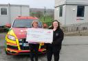 Val Jones presenting the Cheque to a representative from Wales Air Ambulance