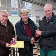 Judge Simon Jenner (right) presents the Christmas Fatstock Cup to Martin Jones watched by Halls chairman Allen Gittins (left).