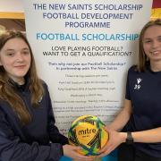 The New Saints FC players Millie Evans (left) and Kiera Tomlinson with details of the scholarship programme.