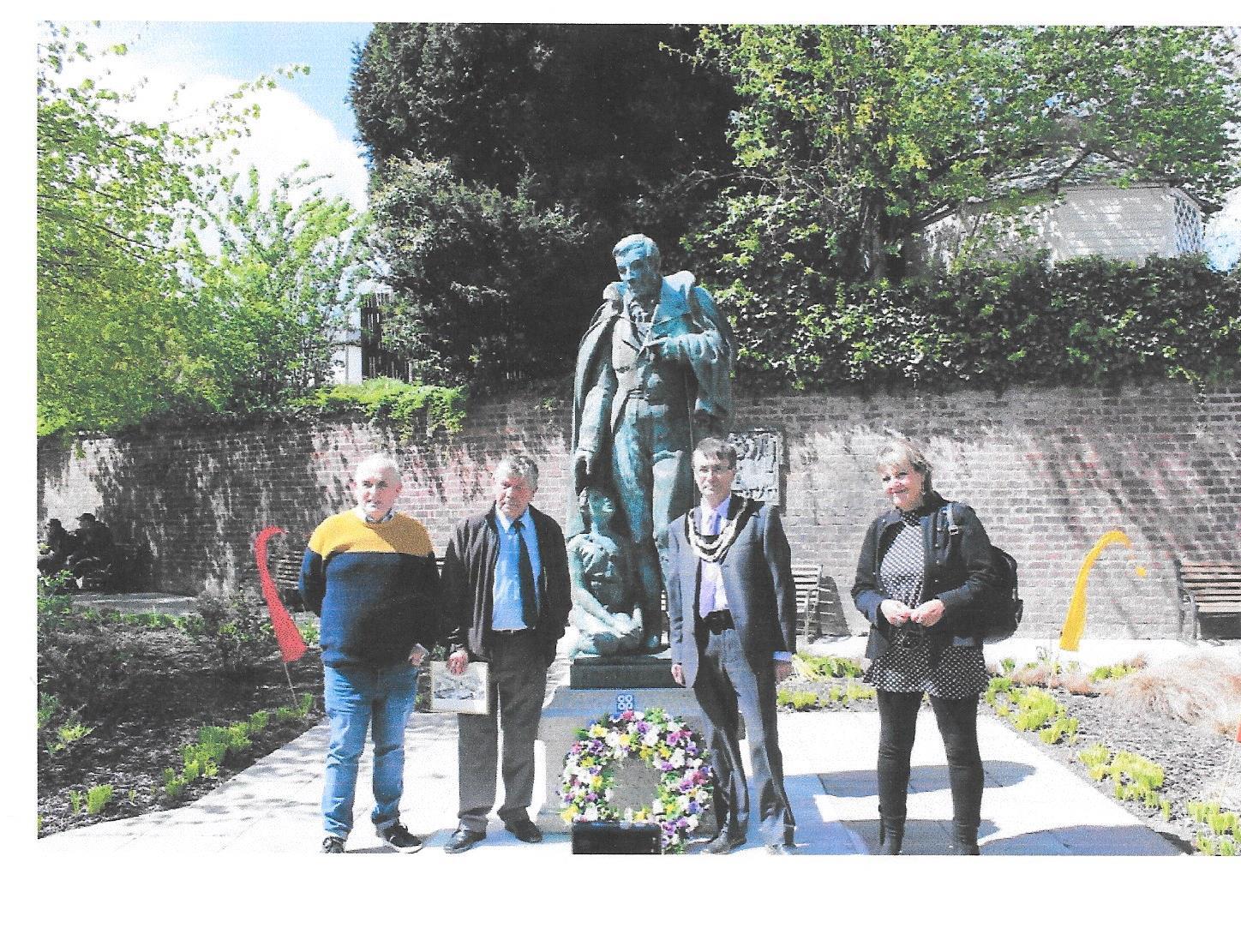 David Smith of Co-op & Mutuals Wales, Mayor David Selby, and Rex Shayler were joined by a representative of Ysgol Dafydd Llwyd at the presentation of a wreath at the statue of Robert Owen. Picture by Andy Newham.
