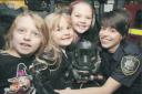 . Oswestry firefighter Gemma Walters gets overfire safety messages to youngsters Lydia Grazyna, Agata and JuliaBakalorz in 2010..