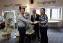Cllr Chris Schofield (L) with former mayor Cllr John Price and library manager Siobhan Shaw at a cheque presentation in 2019.