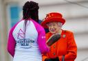 Queen Elizabeth II talks to the first baton bearer, British parasport athlete Kadeena Cox, at the launch of the Queen's Baton Relay for Birmingham 2022 - the XXII Commonwealth Games, on the forecourt of Buckingham Palace in London. Picture date: