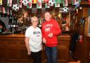 John Turner owner of the Dolphin Inn Pub in Llanymynech, with bar help Sarah Gregory during a screening of the FIFA World Cup Group B match between England and Wales.