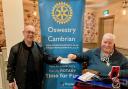 Oswestry Cambrian Rotary Club’s President Roger Whitting handing a cheque for £250 to Simon Jones, a representative from the local Young Carer support group.