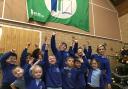 Eco Committee in the school hall with some of the sound insulation pictured above them