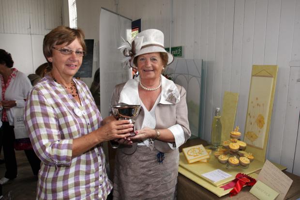 Border Counties Advertizer: Lady President Ann Kynaston presenting a trophy to Dianne Sissons, from Erbistock WI, winner of the table top display.