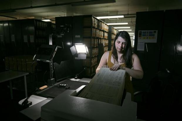 Border Counties Advertizer: Photo via PA shows Findmypast technician Laura Gowing scans individual pages of the 30,000 volumes of the 1921 Census at the Office for National Statistics (ONS) near Southampton.