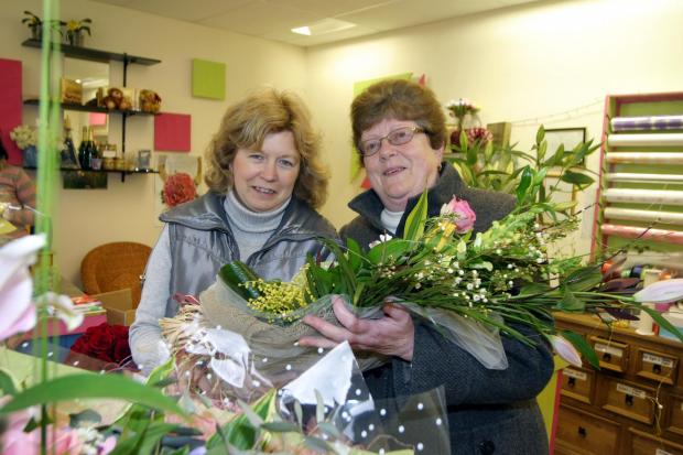 Border Counties Advertizer: Advertizer Mum In A Million competition 2008 winner.The winner, Hazel Edwards, right, receives her prize from Aileen Cooper, owner of The Flower Barn and Courtyard Flowers, Oswestry.HD210208
