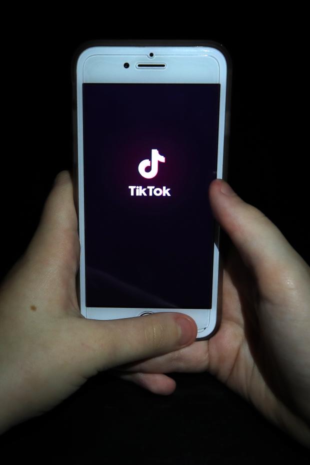 Border Counties Advertizer: A person with TikTok open on their phone. Credit: PA