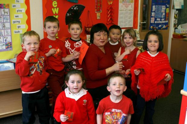Border Counties Advertizer: Reception pupils from Morda Primary School sampled Chinese food, recieved good luck gifts, listened to music and wrote their names in Chinese characters, from left - Jay Hunt, Connor Beardmore, Curtis Weetman, Grace Cookson, who came in to write the