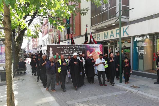 The Ashura procession makes its way through Commercial Street in Newport city centre.