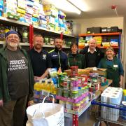 (LtoR) Lionel Parker (foodbank volunteer), Terry Rogers (FC Oswestry Town vice-chairman), Nathan Leonard (FC OSwestry Town manager), Liz Jermy (foodbank manager), Nick Maguire (FC Oswestry Town managing director) and Kath Davies (foodbank volunteer)