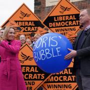 Newly elected Liberal Democrat MP Helen Morgan, bursts 'Boris' bubble' held by colleague Tim Farron, as she celebrates in Oswestry, Shropshire, following her victory in the North Shropshire by-electiom. Picture date: Friday December 17, 2021.