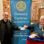 Oswestry Cambrian Rotary Club’s President Roger Whitting handing a cheque for £250 to Simon Jones, a representative from the local Young Carer support group.