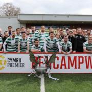 TNS players and management celebrate with the JD Cymru Premier trophy.