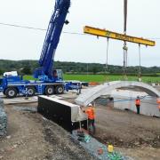 The Schoolhouse Bridge is moved into place.