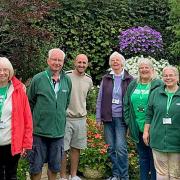 Tom Pountney (centre) with members of Macmillan Cancer Support’s Shrewsbury Fundraising Group in his garden.