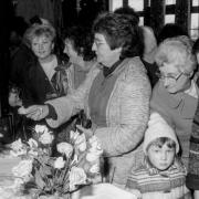 Ladies enjoying a rummage at a jumble sale in Gobowen, 1983.