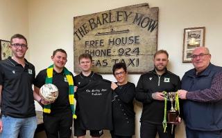 Members of Trefonen FC receive the polo shirts from Heather Hughes of The Barley Mow.